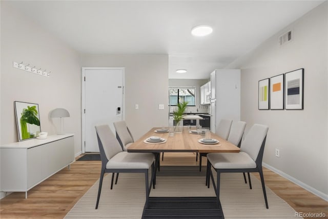 3656 S Depew St Unit 102, Denver, CO 80235 - dining area featuring light wood finished floors and baseboards