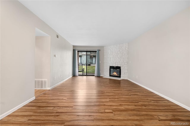 3656 S Depew St Unit 102, Denver, CO 80235 - unfurnished living room featuring wood finished floors, a fireplace, and baseboards