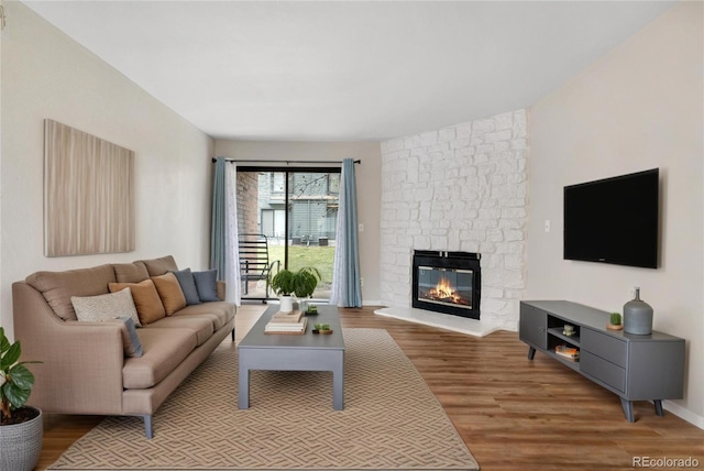 3656 S Depew St Unit 102, Denver, CO 80235 - living area featuring wood finished floors and a stone fireplace