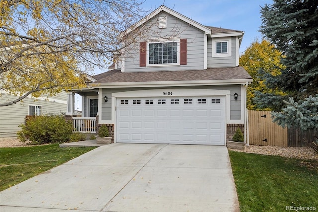 view of property with a front yard and a garage