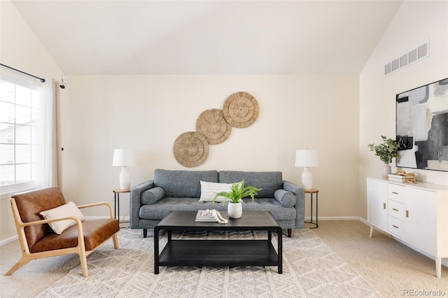 carpeted living room featuring lofted ceiling