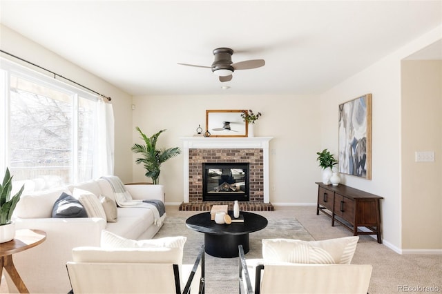 living room featuring ceiling fan, a fireplace, and light colored carpet