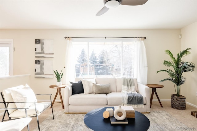 living room featuring light carpet and ceiling fan