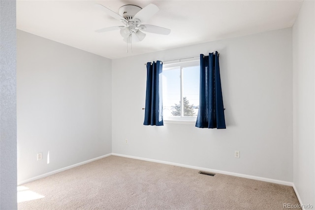 empty room with ceiling fan and carpet floors