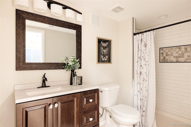 full bathroom featuring vanity, shower / tub combo, and toilet