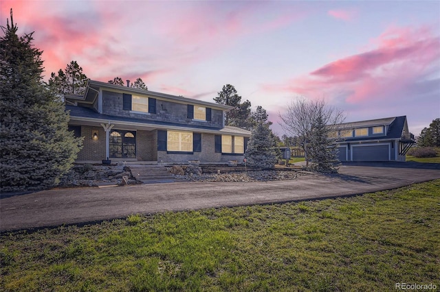 12454 Antelope Trl, Parker, CO 80138 - traditional home featuring driveway, a yard, an attached garage, covered porch, and stone siding