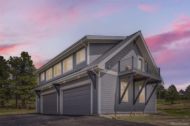 12454 Antelope Trl, Parker, CO 80138 - property exterior at dusk featuring a balcony, a garage, and asphalt driveway