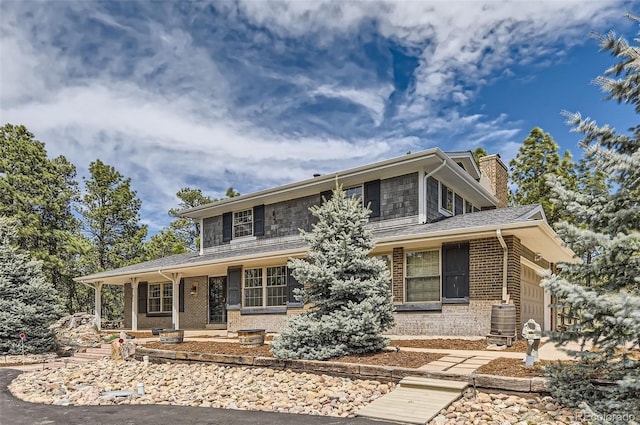 12454 Antelope Trl, Parker, CO 80138 - view of front of home featuring a chimney, brick siding, and roof with shingles