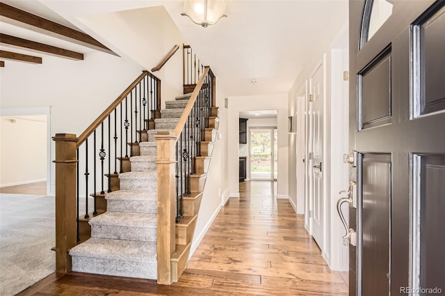 12454 Antelope Trl, Parker, CO 80138 - foyer with stairs, light wood-style floors, and beam ceiling