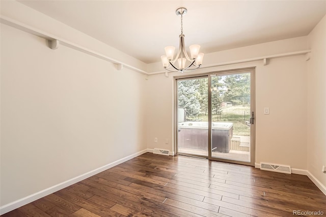 12454 Antelope Trl, Parker, CO 80138 - spare room featuring a chandelier and dark wood-type flooring