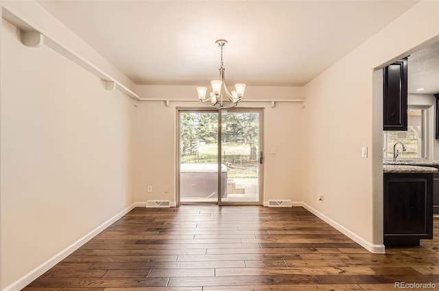 12454 Antelope Trl, Parker, CO 80138 - unfurnished dining area featuring a chandelier and dark wood-type flooring