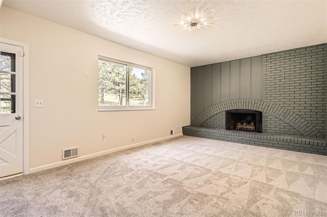 12454 Antelope Trl, Parker, CO 80138 - unfurnished living room featuring healthy amount of natural light, a textured ceiling, carpet flooring, and a brick fireplace