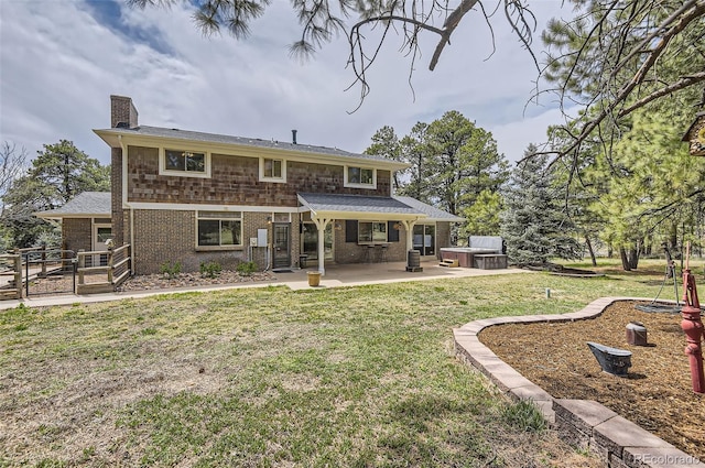 12454 Antelope Trl, Parker, CO 80138 - rear view of property featuring a hot tub, a patio, a chimney, and brick siding