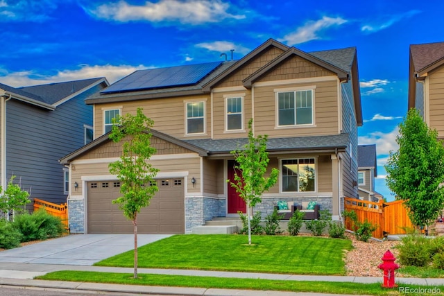 craftsman inspired home featuring solar panels and a front yard