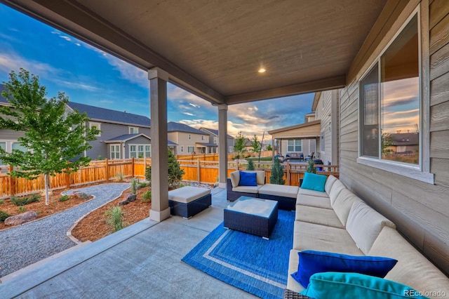 patio terrace at dusk featuring outdoor lounge area