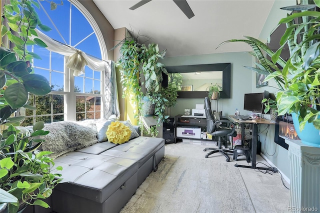 office area featuring light carpet, vaulted ceiling, and ceiling fan