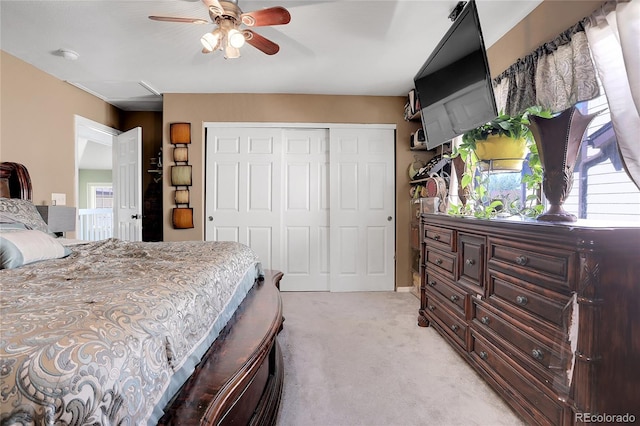 bedroom with light carpet, a closet, and ceiling fan