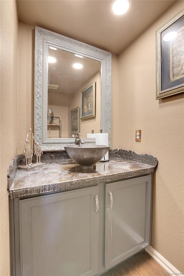 bathroom featuring vanity and hardwood / wood-style floors