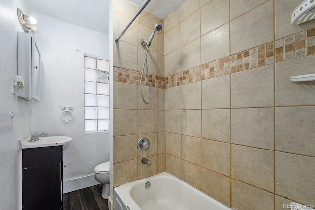 full bathroom featuring toilet, shower / bathtub combination, wood finished floors, and vanity