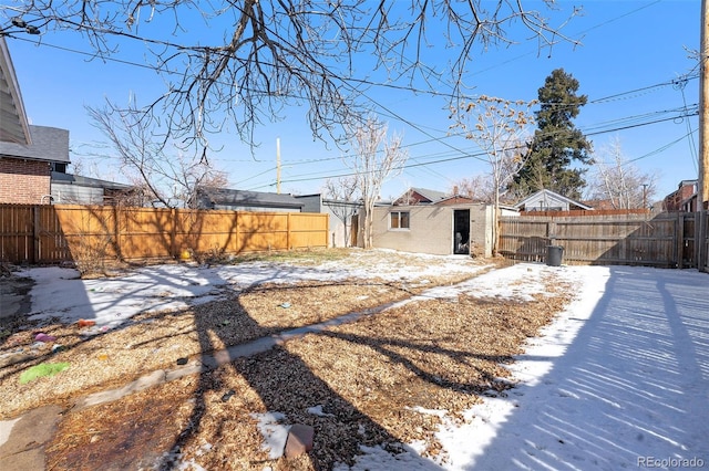 yard layered in snow featuring a fenced backyard