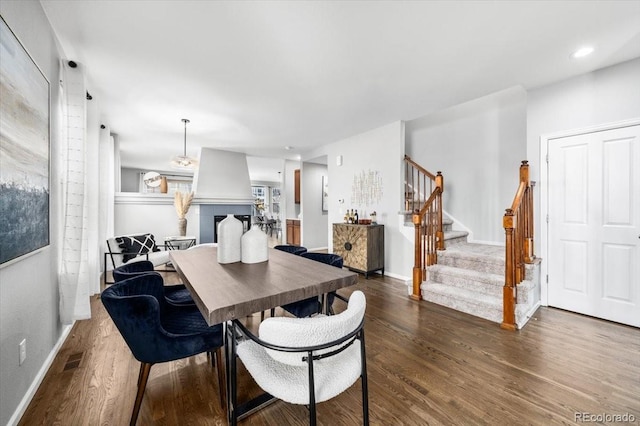 dining area featuring recessed lighting, visible vents, stairway, wood finished floors, and baseboards