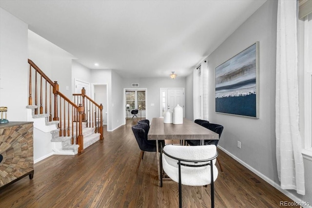 dining room with stairs, dark wood-style floors, visible vents, and baseboards