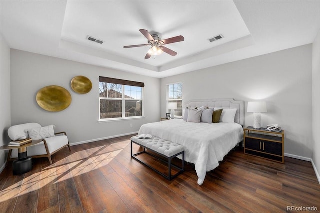 bedroom featuring a raised ceiling and visible vents