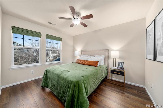 bedroom featuring wood-type flooring, visible vents, and baseboards