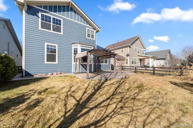 rear view of house with board and batten siding, fence, a yard, a patio area, and a pergola