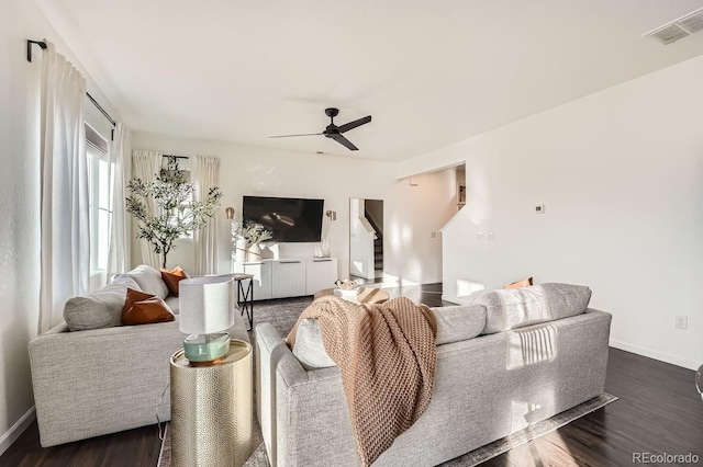 living room with ceiling fan and dark hardwood / wood-style floors