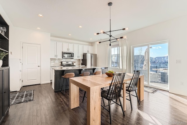 dining room featuring dark hardwood / wood-style floors and a chandelier