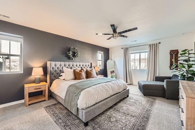 carpeted bedroom with a textured ceiling and ceiling fan