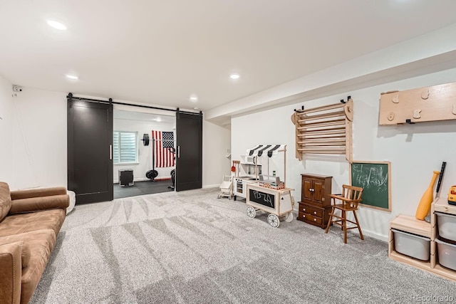 interior space featuring a barn door and dark carpet