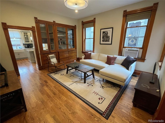 2335 Stout St, Denver, CO 80205 - living area with light wood-style flooring and cooling unit