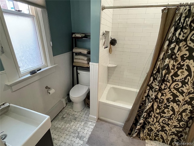 2335 Stout St, Denver, CO 80205 - bathroom featuring toilet, a sink, shower / bathtub combination with curtain, and wainscoting