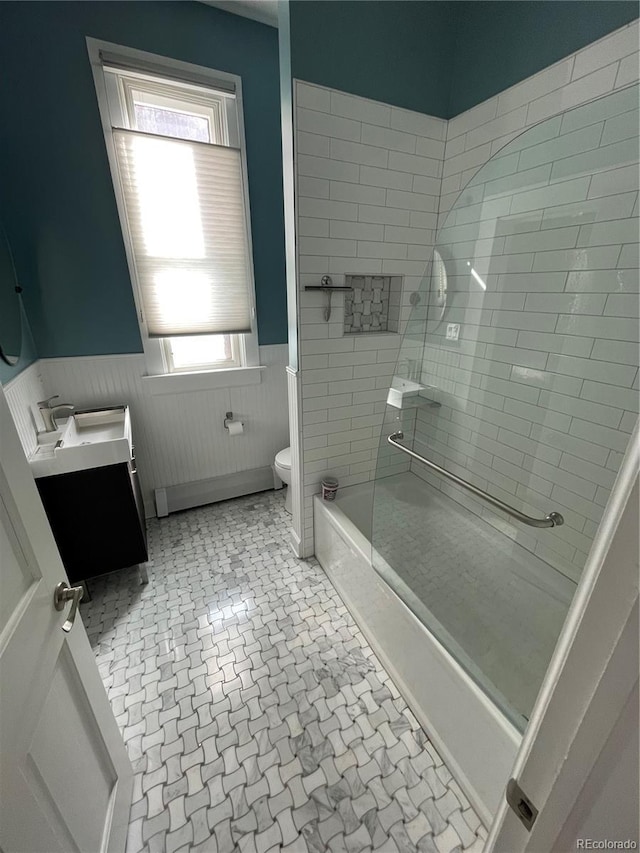 2335 Stout St, Denver, CO 80205 - full bath featuring wainscoting, vanity, toilet, and shower / washtub combination