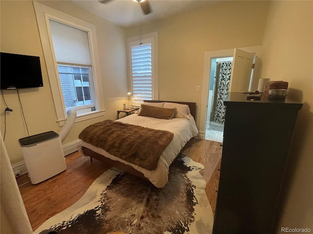 2335 Stout St, Denver, CO 80205 - bedroom featuring wood finished floors, baseboards, and a ceiling fan