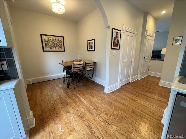 2335 Stout St, Denver, CO 80205 - dining space featuring arched walkways, wood finished floors, baseboards, and recessed lighting