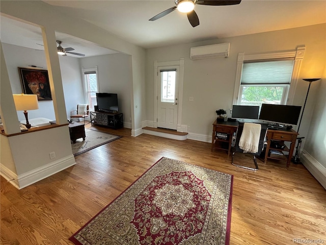 2335 Stout St, Denver, CO 80205 - living area with ceiling fan, a wall mounted AC, and healthy amount of natural light