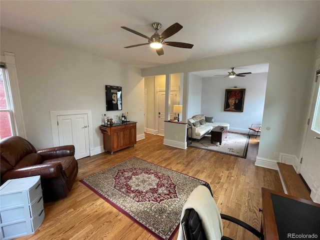 2335 Stout St, Denver, CO 80205 - living room with a ceiling fan, light wood-style flooring, and baseboards