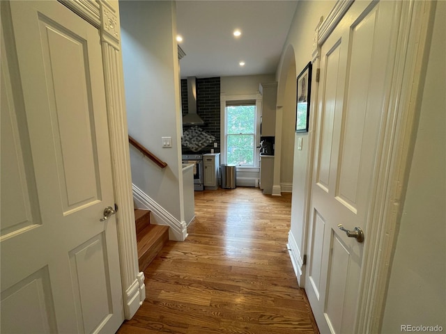 2335 Stout St, Denver, CO 80205 - hallway with wood finished floors, recessed lighting, stairway, and baseboards