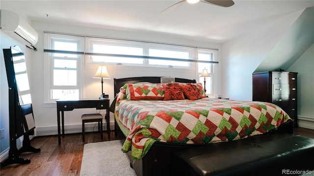 2335 Stout St, Denver, CO 80205 - bedroom featuring a wall unit AC, wood finished floors, and baseboards
