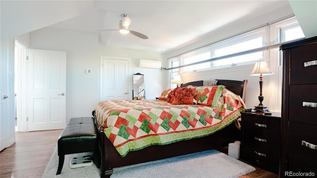 2335 Stout St, Denver, CO 80205 - bedroom with wood finished floors, an AC wall unit, ceiling fan, and a closet