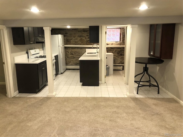 2335 Stout St, Denver, CO 80205 - kitchen with white appliances, a sink, a baseboard radiator, light countertops, and light tile patterned floors