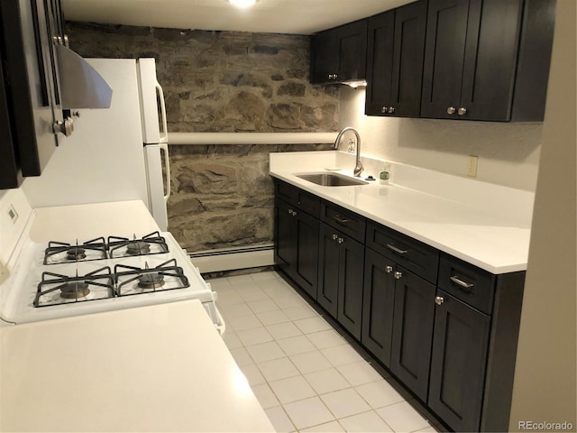 2335 Stout St, Denver, CO 80205 - kitchen featuring baseboard heating, dark cabinets, a sink, and light countertops