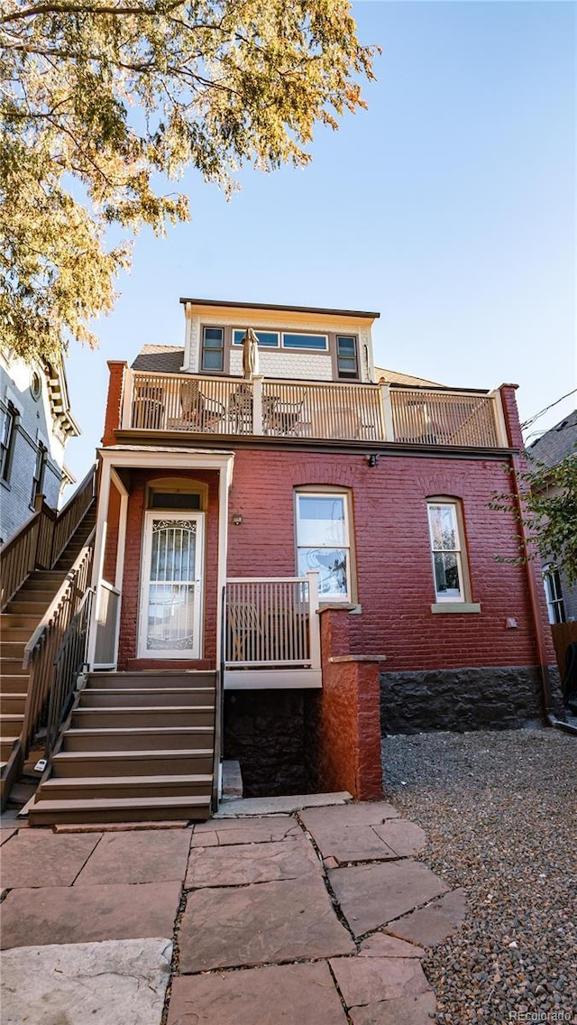 2335 Stout St, Denver, CO 80205 - view of front of home featuring brick siding and stairway