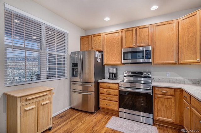 kitchen with appliances with stainless steel finishes and light wood-type flooring