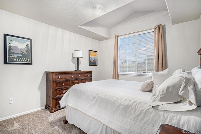 carpeted bedroom featuring lofted ceiling