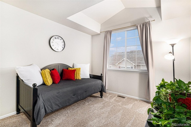 bedroom featuring lofted ceiling and light carpet