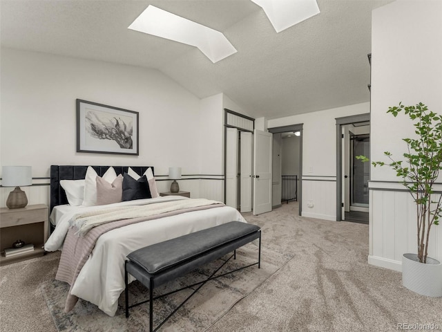 19726 Applewood Ct, Parker, CO 80138 - bedroom with a skylight, light colored carpet, vaulted ceiling, and wainscoting